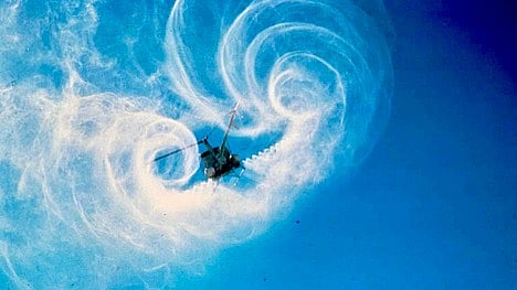 A helicopter sprays product 
