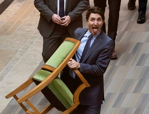 Justin Trudeau carries his chair out of the House of Commons 