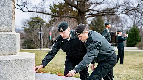 Members of the Canadian Armed Forces and National Cemetery Representatives place poppies at the Arlington National Cemetery